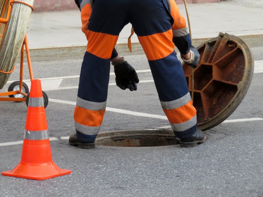 man going into sewer