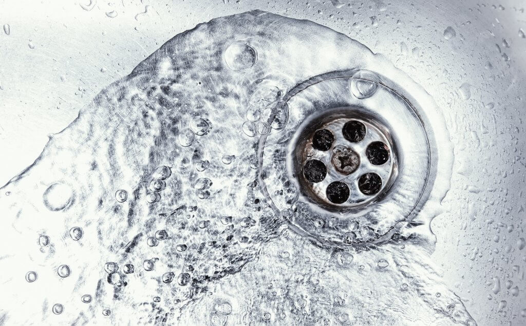 A sink with water flowing after trenchless sewer line repair in El Paso